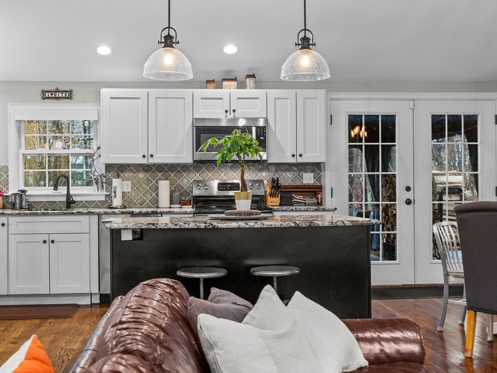 237 York Street Canton, MA 02021 - Photo 12 of 42 a kitchen with kitchen island granite countertop a sink cabinets and window
