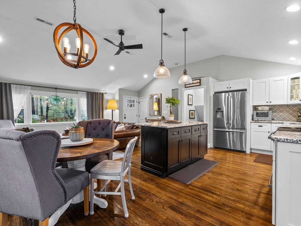 237 York Street Canton, MA 02021 - Photo 13 of 42 a dining room with wooden floor a chandelier a wooden table and chairs
