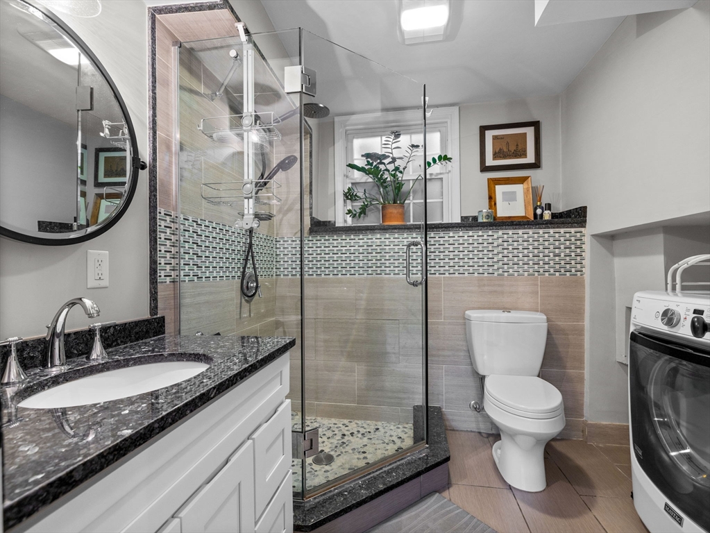 237 York Street Canton, MA 02021 - Photo 23 of 42 a bathroom with a granite countertop toilet sink and mirror