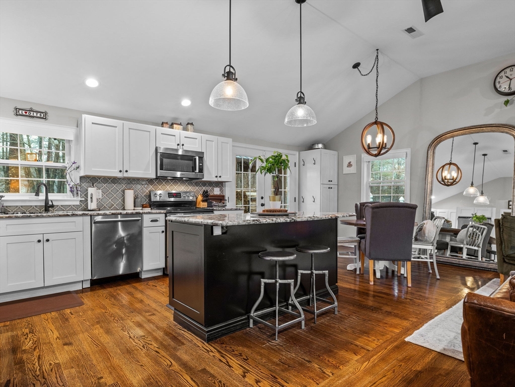 237 York Street Canton, MA 02021 - Photo 7 of 42 a kitchen with stainless steel appliances granite countertop a stove a refrigerator a oven a sink with a dining table and chairs