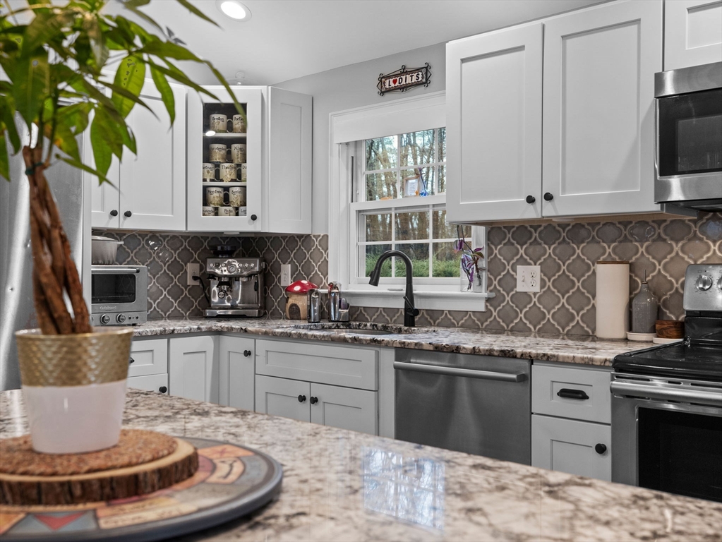 237 York Street Canton, MA 02021 - Photo 10 of 42 a kitchen with a stove a sink and a window