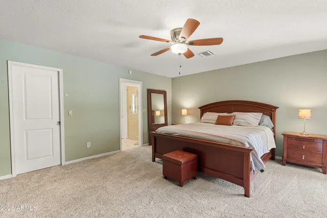 a view of patio with chairs and table under an umbrella