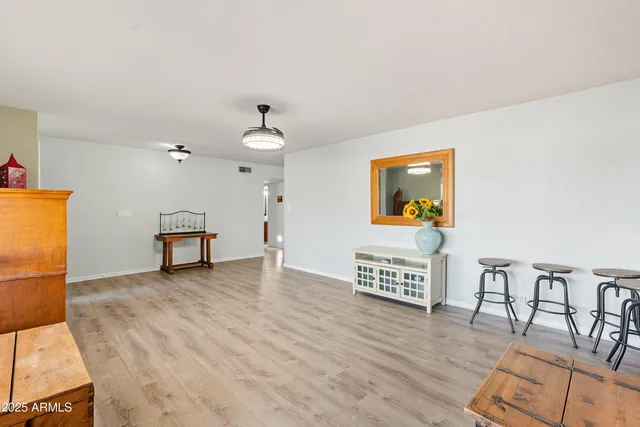 a living room with furniture a dining table and a potted plant