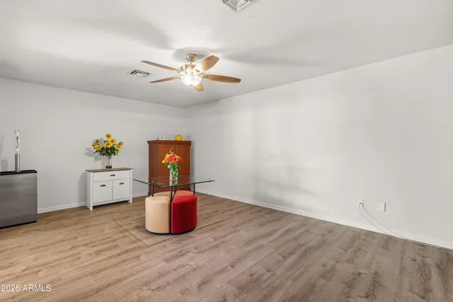 a spacious bedroom with a bed and a flat screen tv