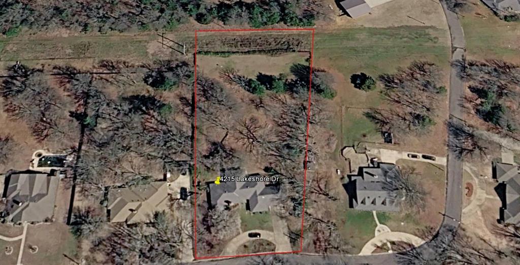 4315 Lakeshore Drive Reno, TX 75462 - Photo 20 of 20 a view of a lake with a building in the background