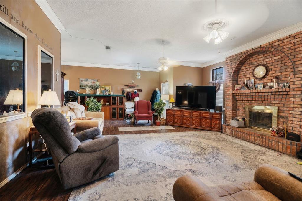 4315 Lakeshore Drive Reno, TX 75462 - Photo 4 of 20 a living room with furniture a flat screen tv and a fireplace