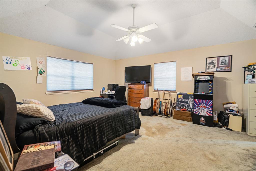 4315 Lakeshore Drive Reno, TX 75462 - Photo 10 of 20 a bedroom with bed a flat tv screen and a dresser with the shoe rack