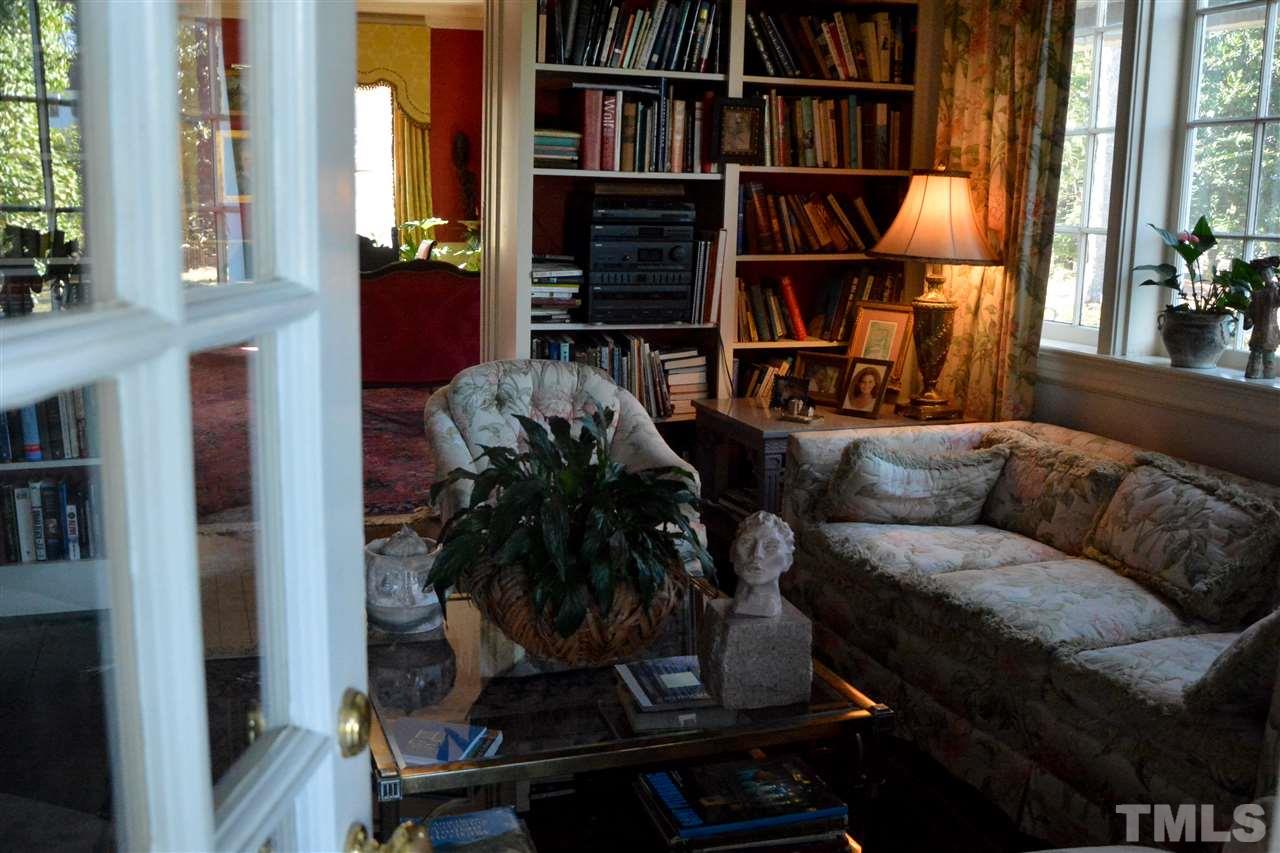 2120 White Oak Road Raleigh, NC 27608 - Photo 8 of 10 a living room with furniture a bookshelf and a window