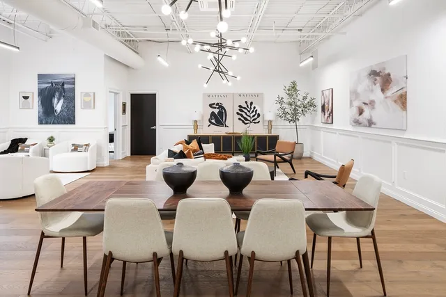 a view of a dining room with furniture and a chandelier