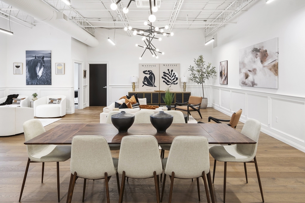 a view of a dining room with furniture and a chandelier