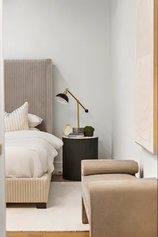 a bedroom with a bed and wooden floor