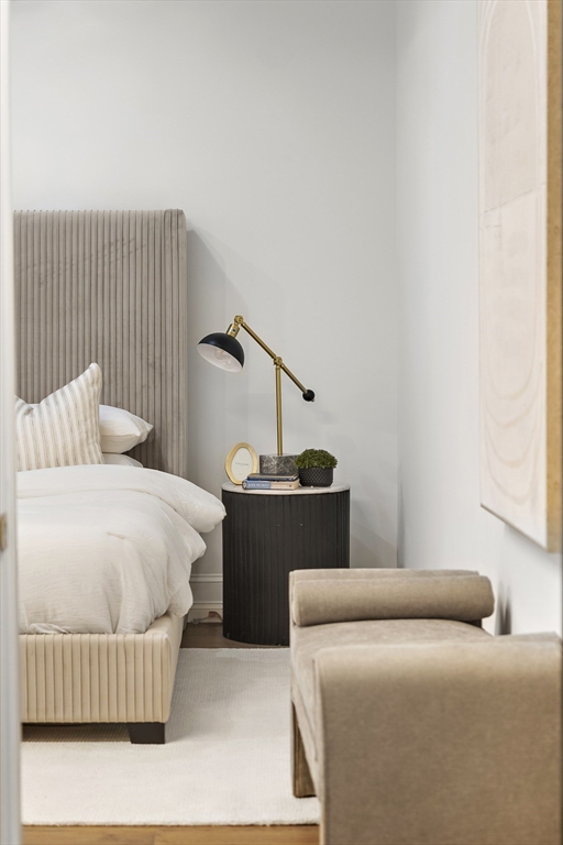 147 Sherman Street, Unit 201 Cambridge, MA 02140 - Photo 24 of 33 a bedroom with a bed and wooden floor