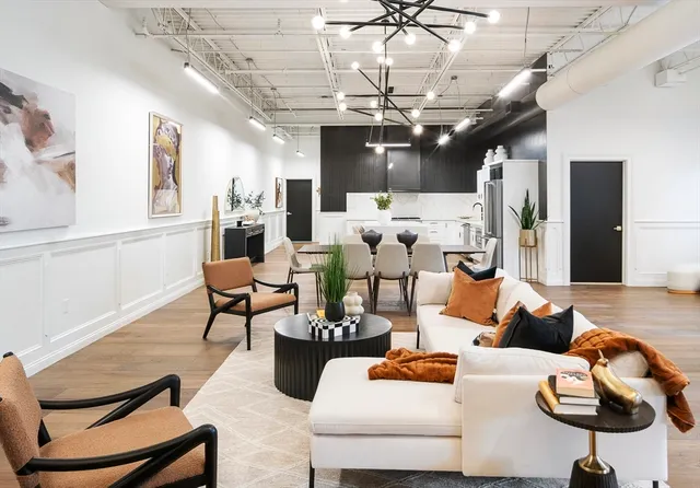a living room with furniture and a chandelier