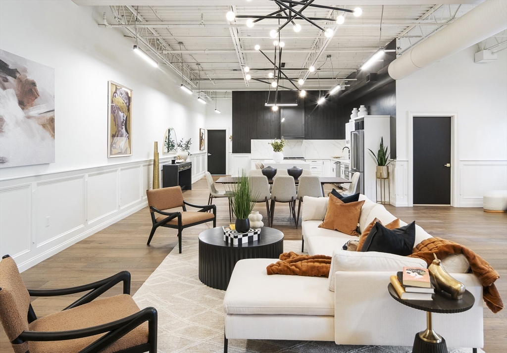 147 Sherman Street, Unit 201 Cambridge, MA 02140 - Photo 28 of 33 a living room with furniture and a chandelier