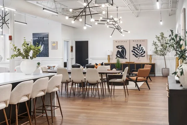 a view of a dining room with furniture wooden floor and chandelier