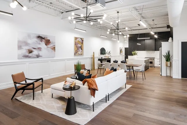 a living room with lots of furniture and a chandelier