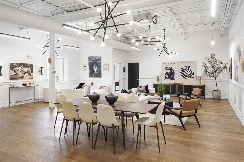 147 Sherman Street, Unit 201 Cambridge, MA 02140 - Photo 9 of 33 a view of a dining room with furniture a chandelier and wooden floor