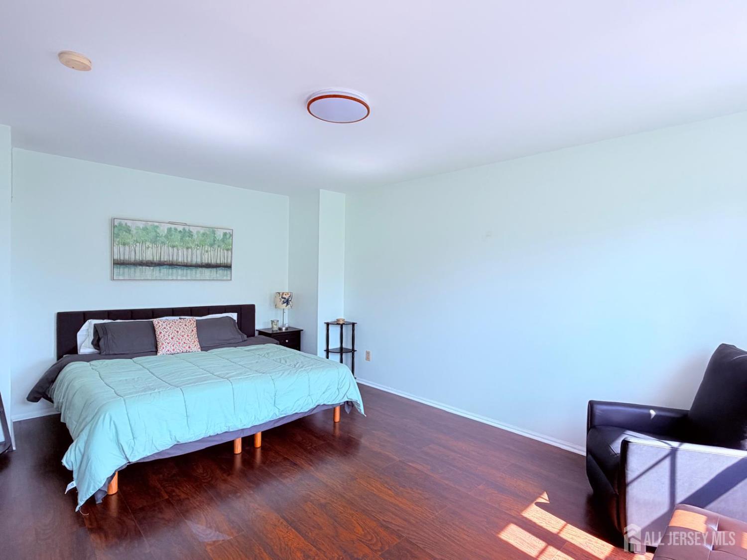 918 Plymouth Road North Brunswick, NJ 08902 - Photo 16 of 30 a bedroom with a bed and wooden floor