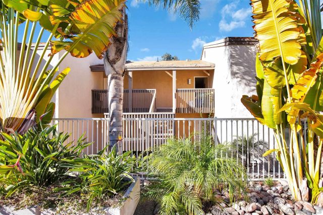 a front view of a house with a yard and a garden