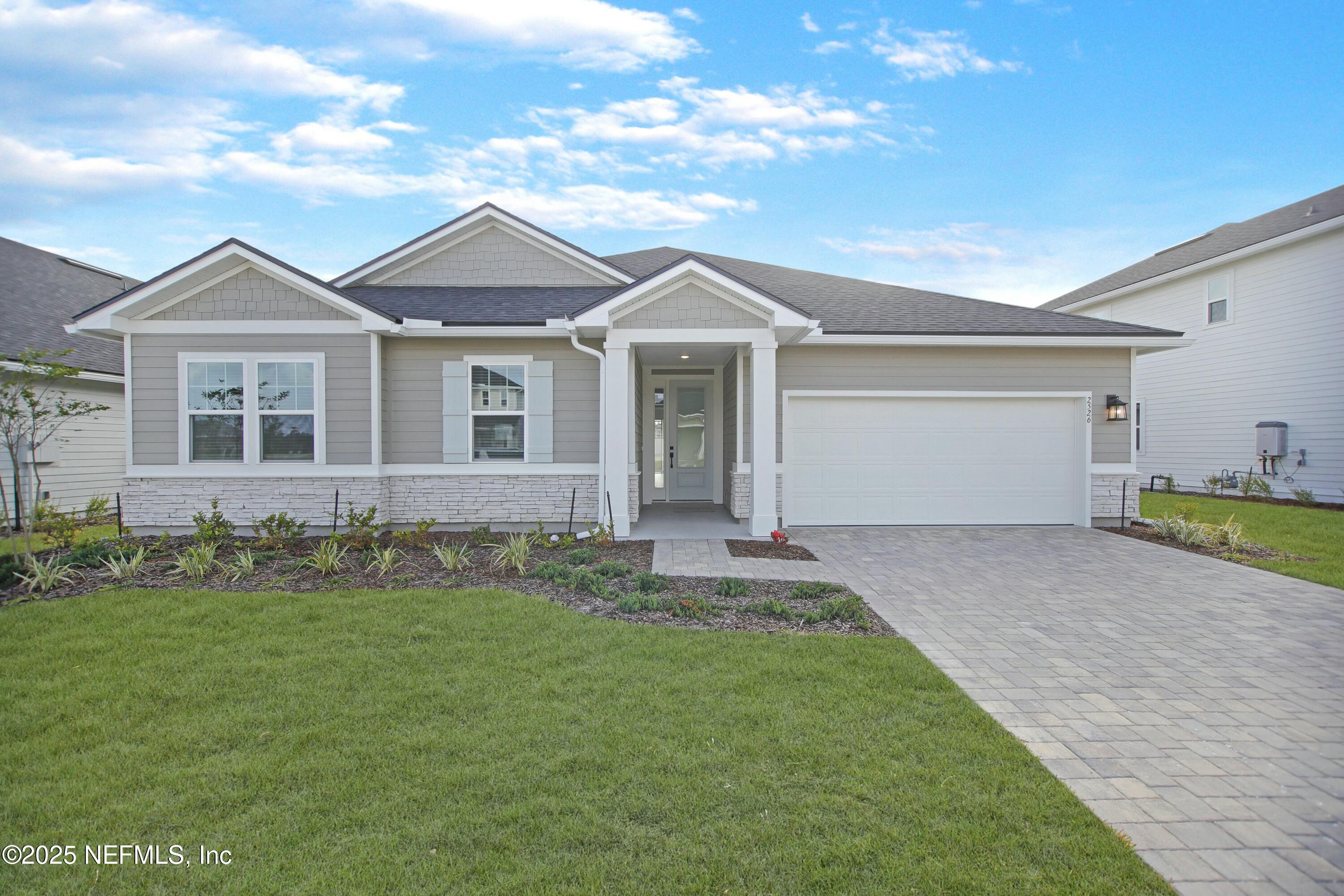 2526 Trailmark Drive St. Augustine, FL 32092 - Photo 1 of 46 a front view of a house with a garden
