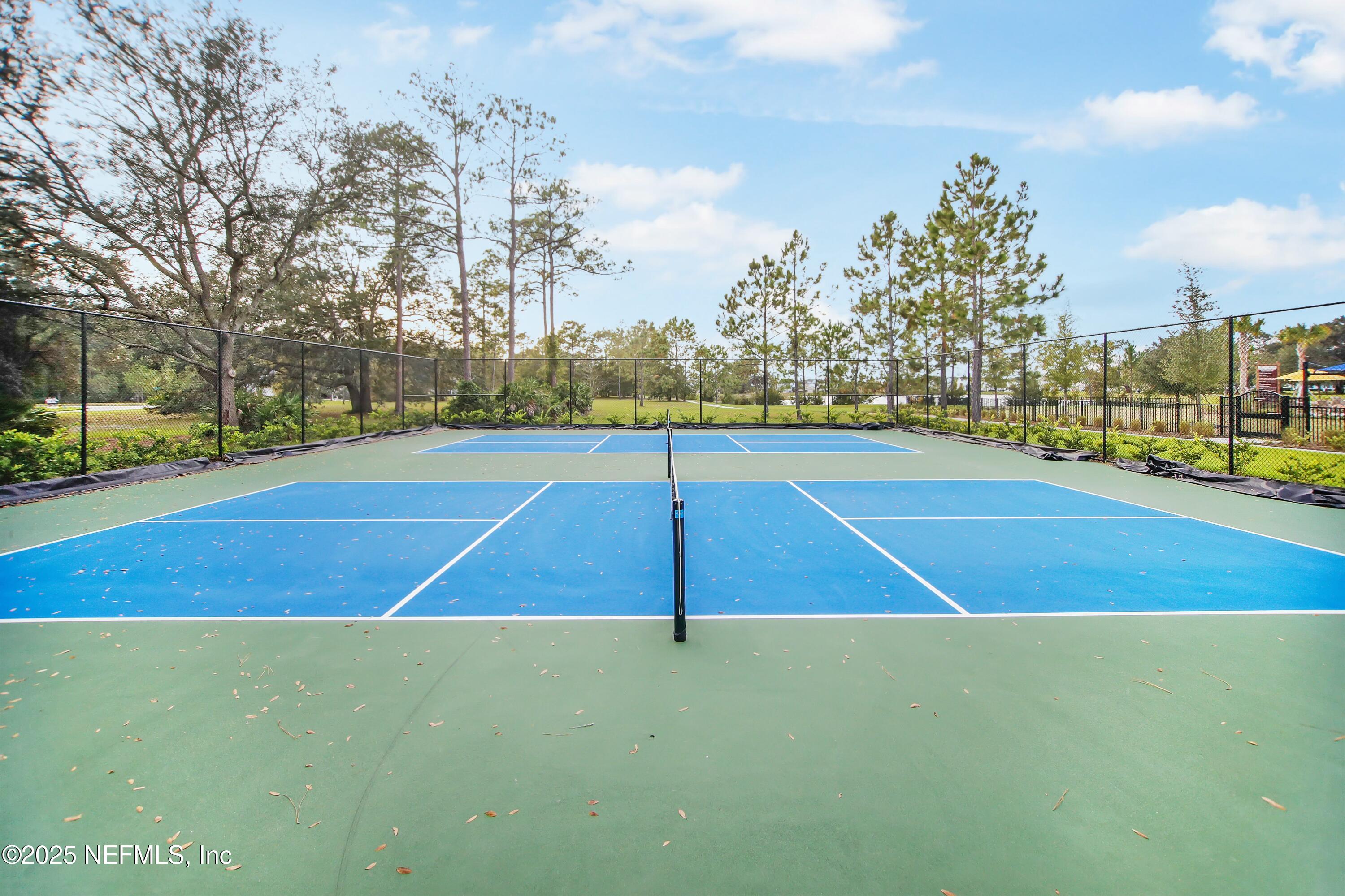 2526 Trailmark Drive St. Augustine, FL 32092 - Photo 34 of 46 a view of an outdoor space and tennis court