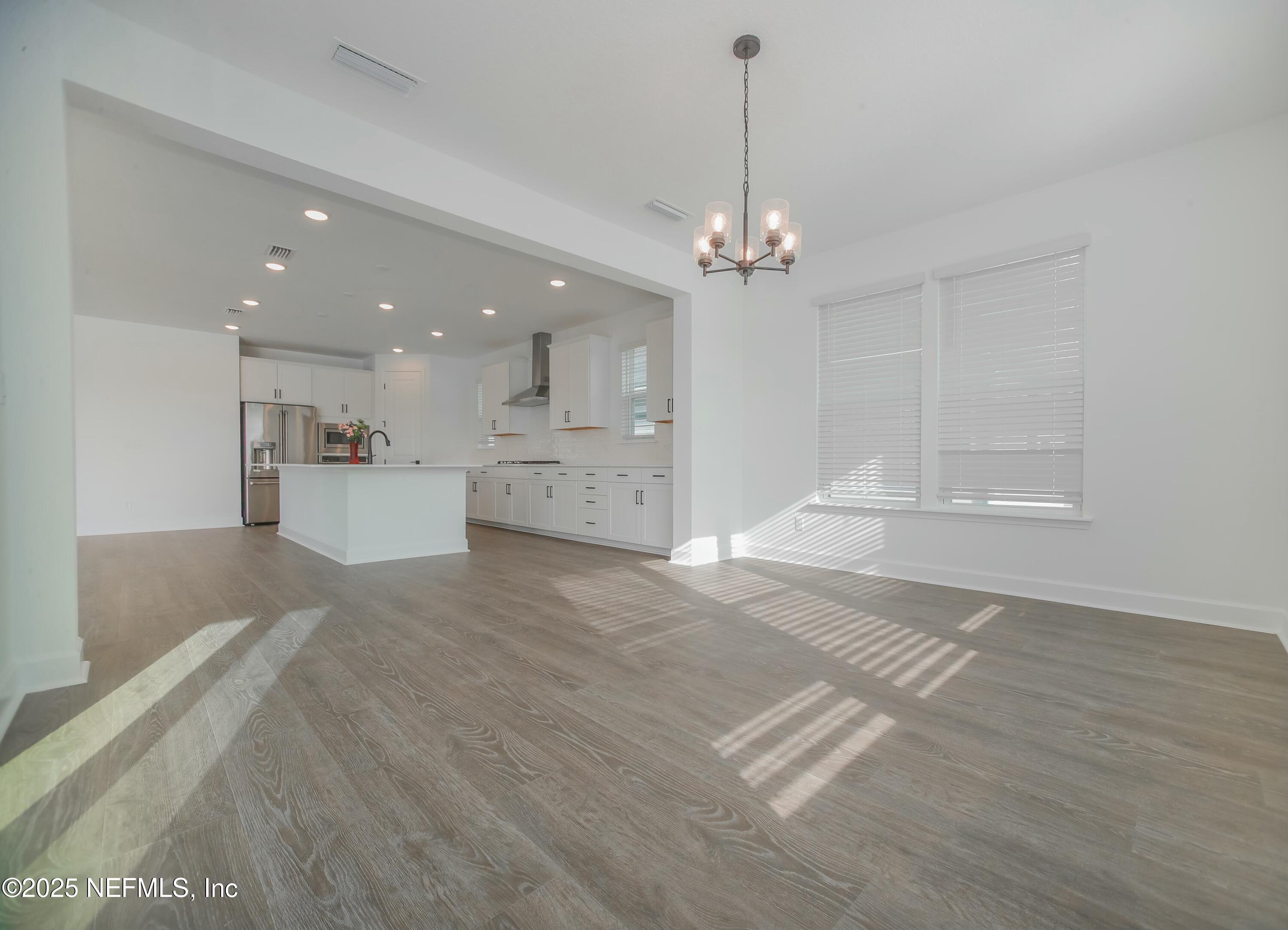 2526 Trailmark Drive St. Augustine, FL 32092 - Photo 9 of 46 a view of a kitchen with a sink dishwasher a stove and kitchen view with wooden floor