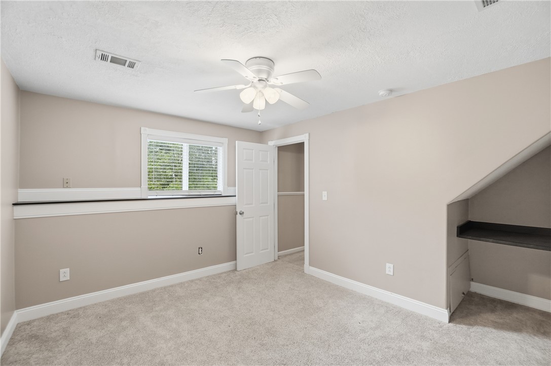 1208 Jarva Lane Springboro, OH 45066 - Photo 48 of 75 Bright and airy bedroom with a ceiling fan, plush carpeting, and a built-in desk nook.