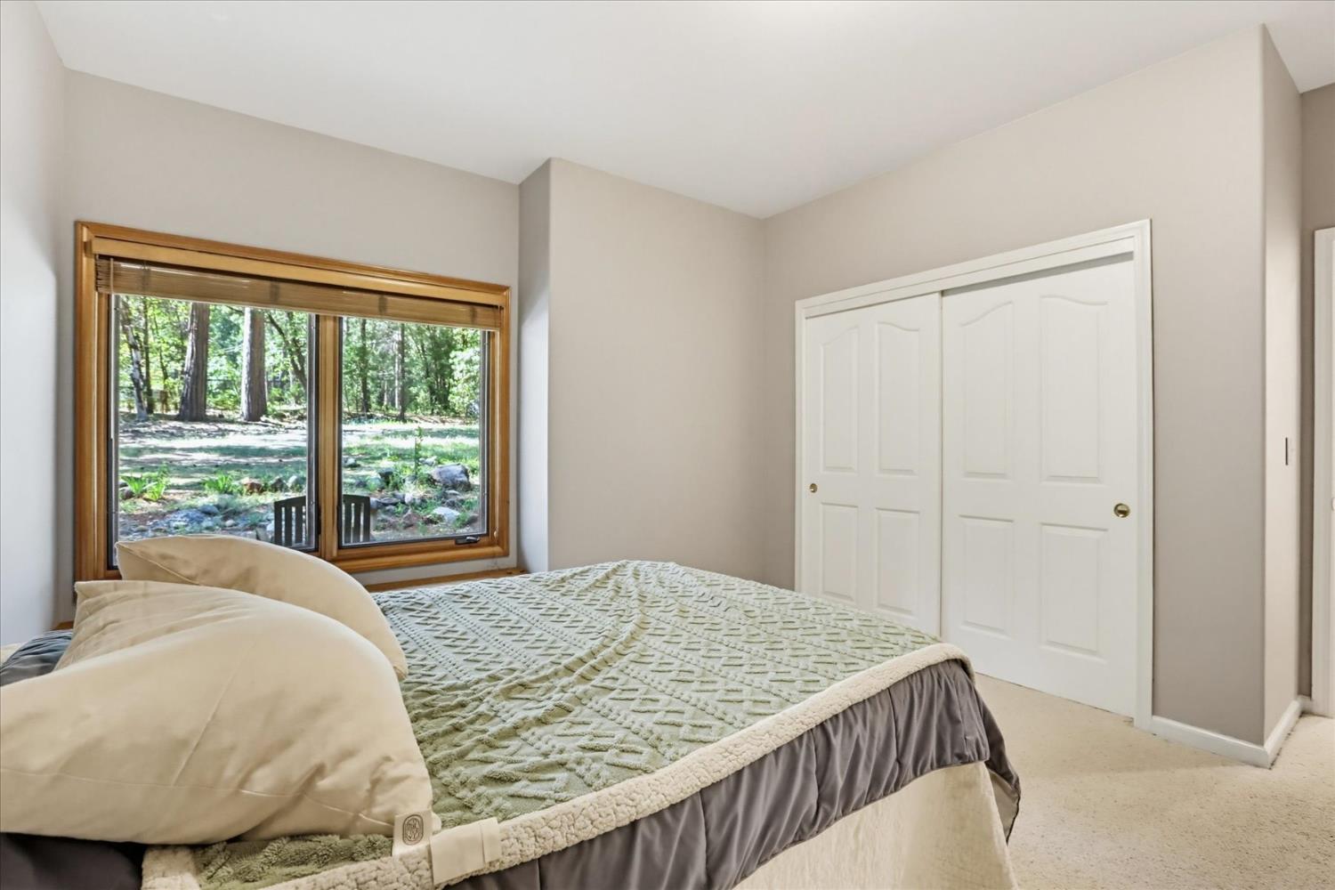 14517 North Bloomfield Road Nevada City, CA 95959 - Photo 39 of 78 a bed sitting in a bedroom next to a window