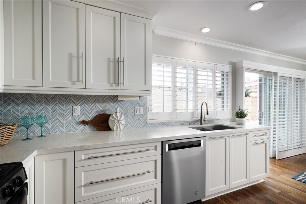 14241 Blackpool Road Westminster, CA 92683 - Photo 7 of 31 a kitchen with stainless steel appliances granite countertop a sink and a white cabinets