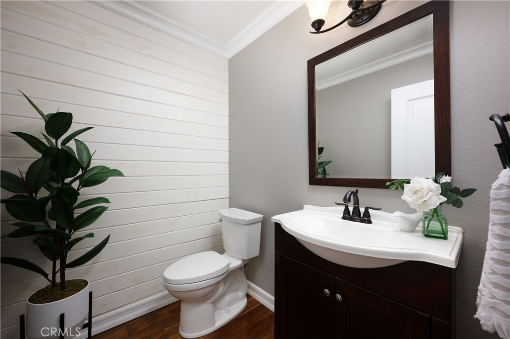 14241 Blackpool Road Westminster, CA 92683 - Photo 8 of 31 a bathroom with a toilet a sink and mirror