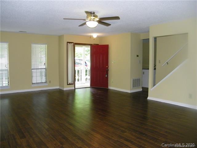 9301 Chislehurst Road Mint Hill, NC 28227 - Photo 3 of 9 a view of an empty room with window and wooden floor