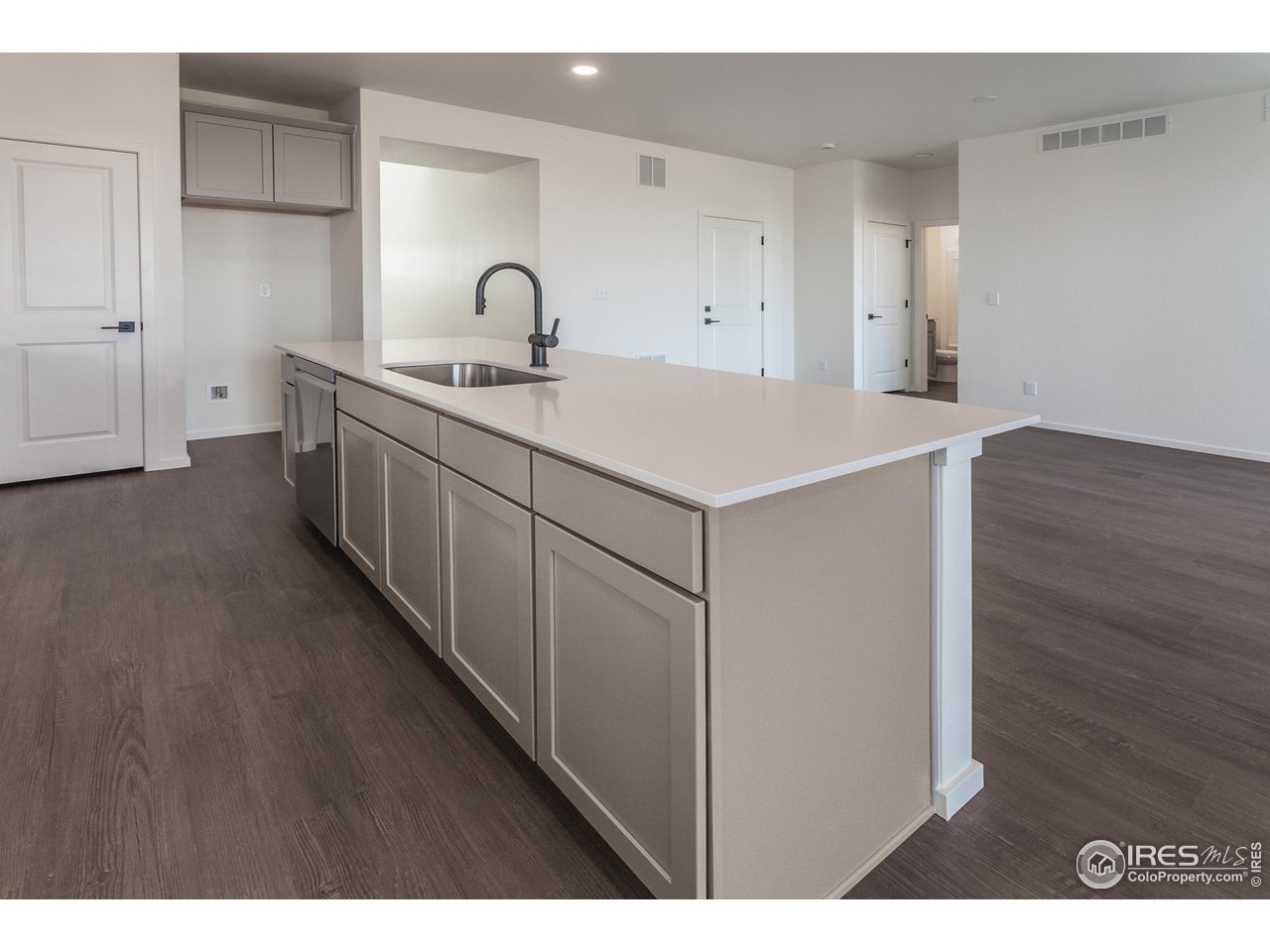 768 Chatter Road Windsor, CO 80550 - Photo 12 of 37 a kitchen with a sink and cabinets