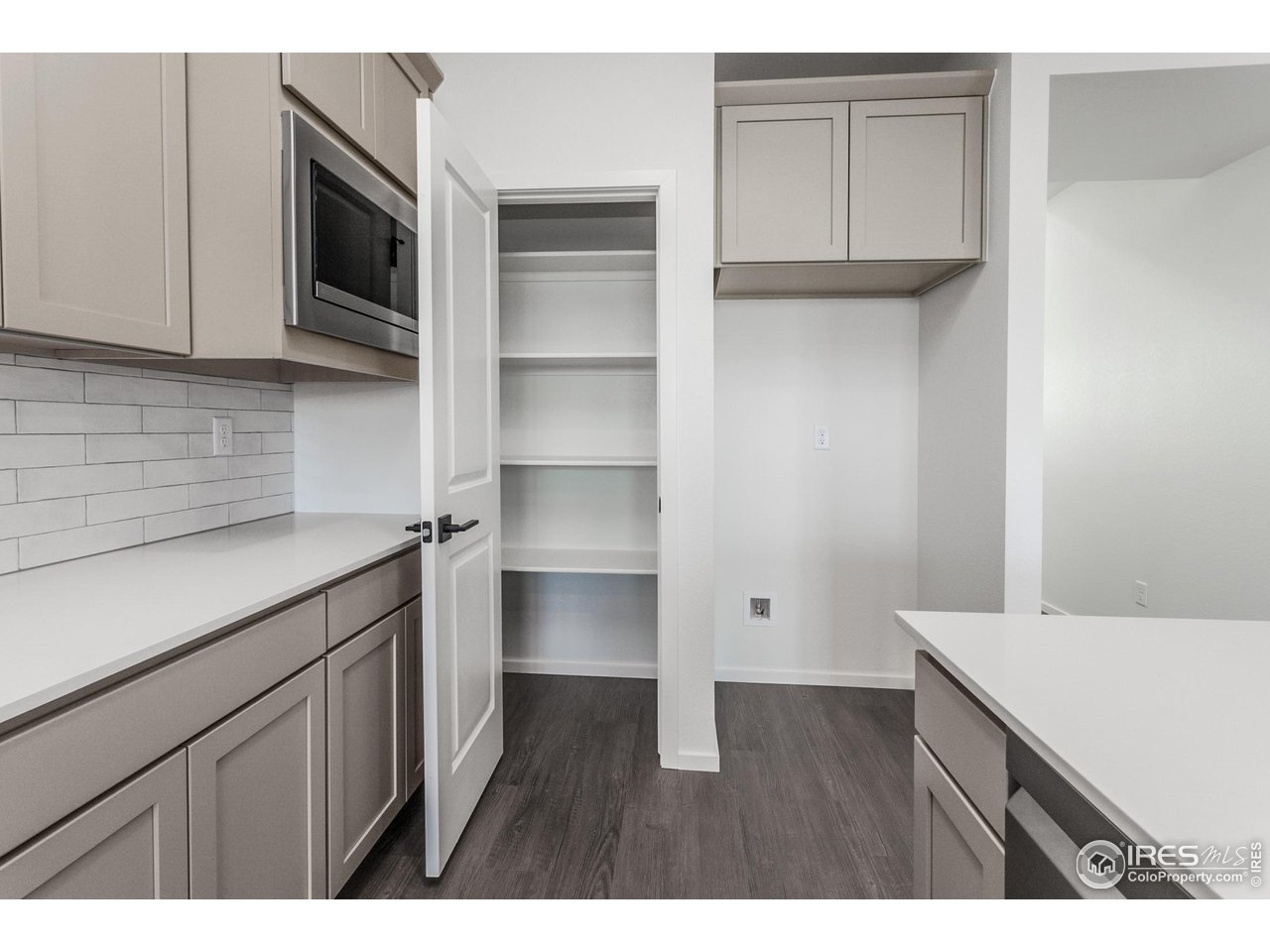 768 Chatter Road Windsor, CO 80550 - Photo 14 of 37 a kitchen with white cabinets