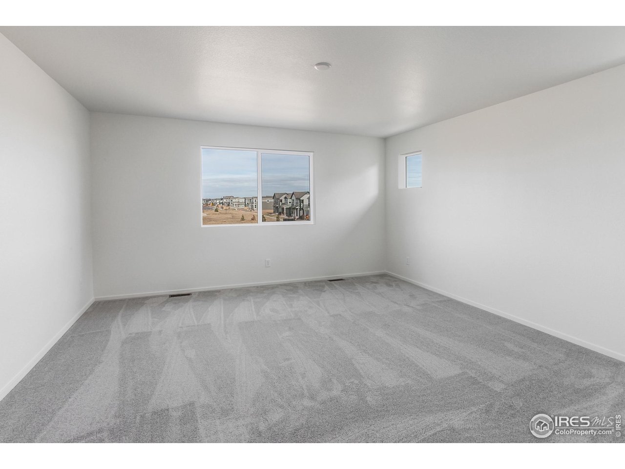 768 Chatter Road Windsor, CO 80550 - Photo 20 of 37 a view of an empty room with a window