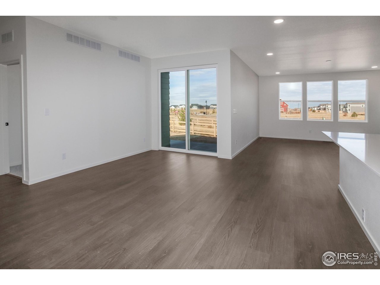 768 Chatter Road Windsor, CO 80550 - Photo 37 of 37 a view of an empty room with a window and wooden floor
