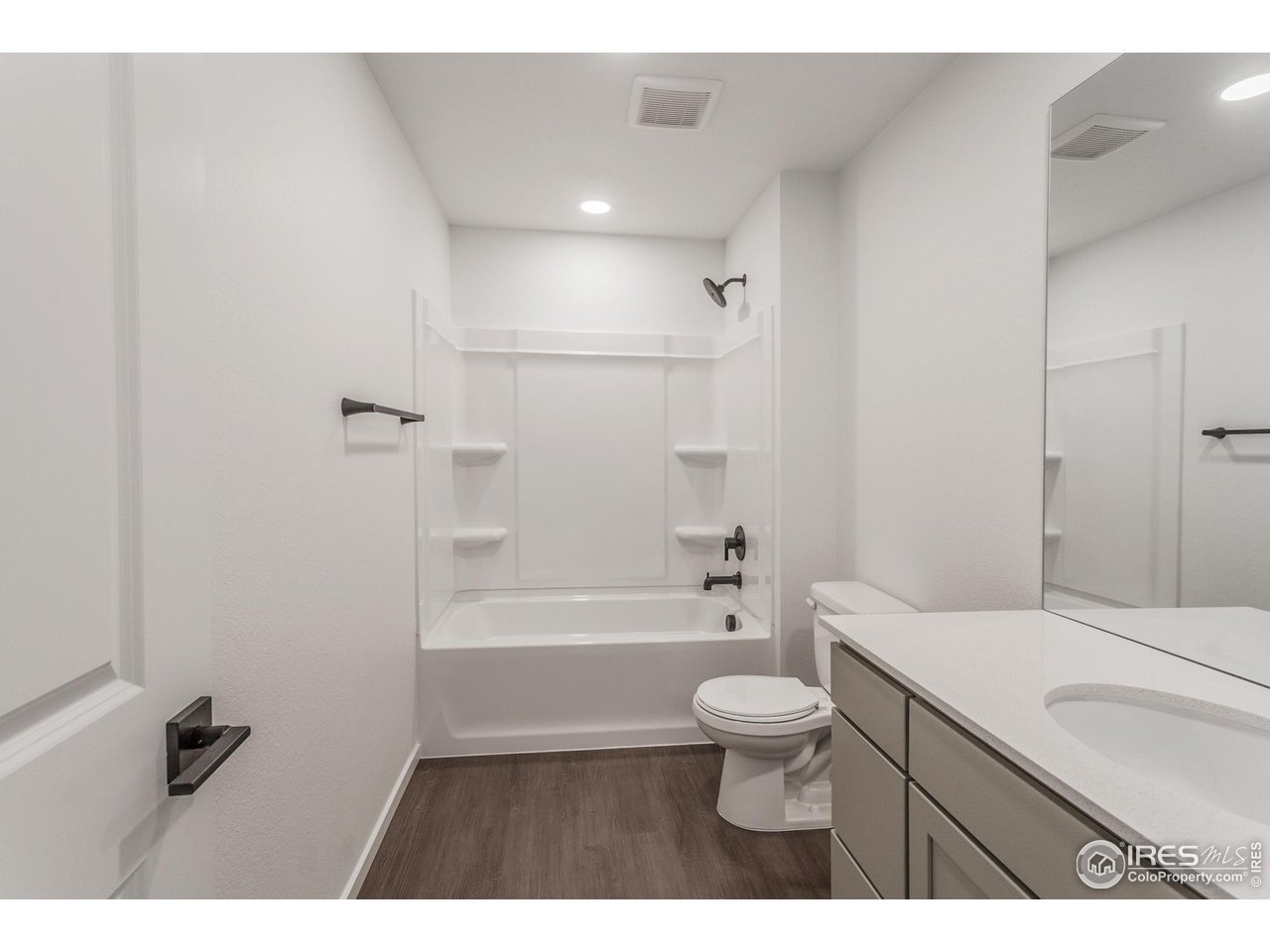 768 Chatter Road Windsor, CO 80550 - Photo 30 of 37 a bathroom with a sink a toilet a mirror and bathtub