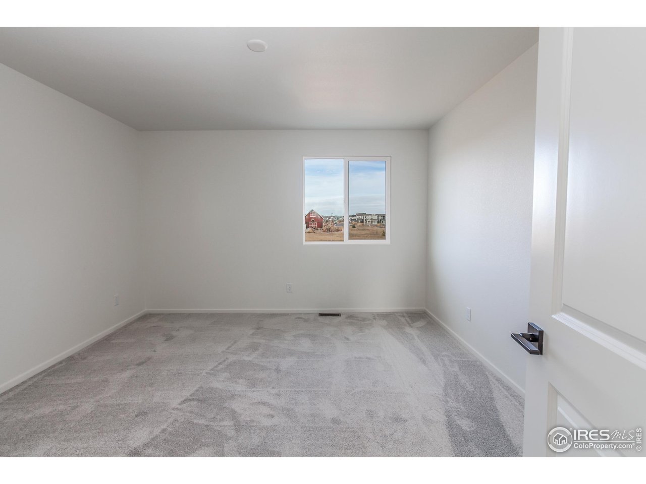 768 Chatter Road Windsor, CO 80550 - Photo 31 of 37 an empty room with windows
