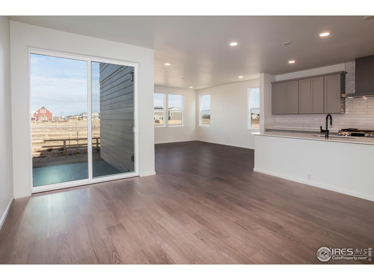 768 Chatter Road Windsor, CO 80550 - Photo 3 of 37 a view of a kitchen cabinets and wooden floor