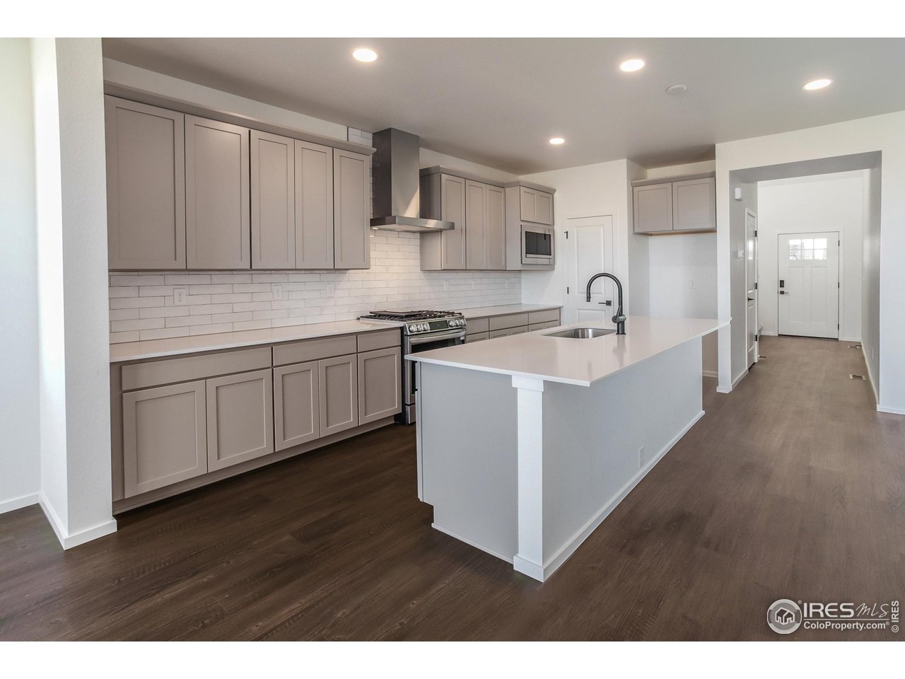 768 Chatter Road Windsor, CO 80550 - Photo 6 of 37 a kitchen that has a sink and a stove in it