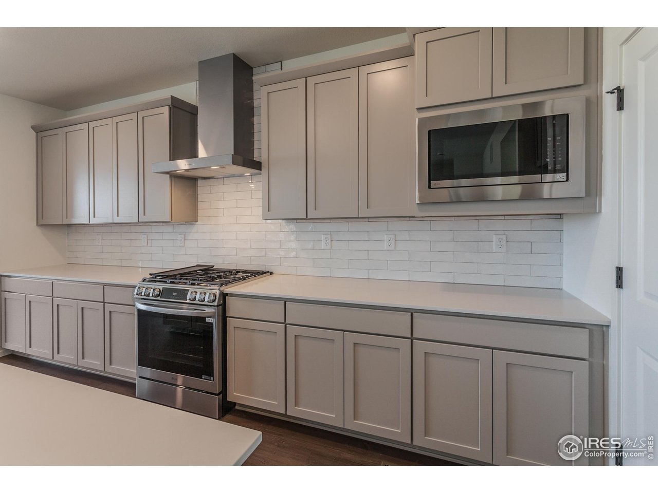 768 Chatter Road Windsor, CO 80550 - Photo 9 of 37 a kitchen with stainless steel appliances granite countertop a stove a microwave and cabinets