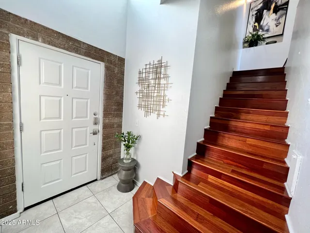 a view of entryway and hall with wooden floor