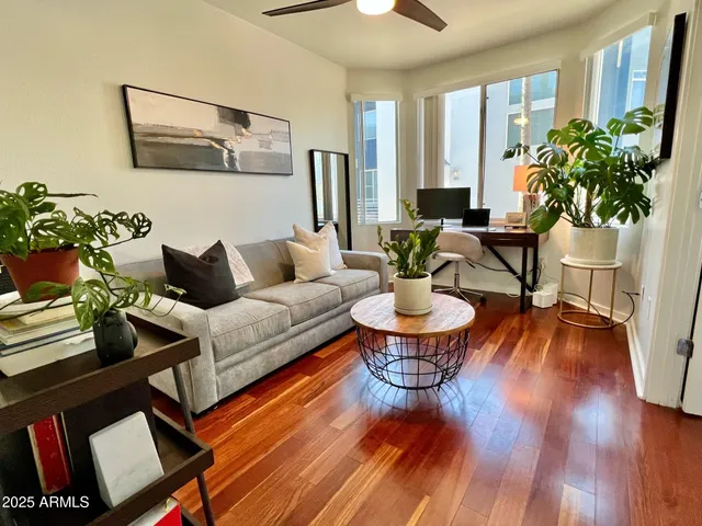 a living room with furniture and wooden floor