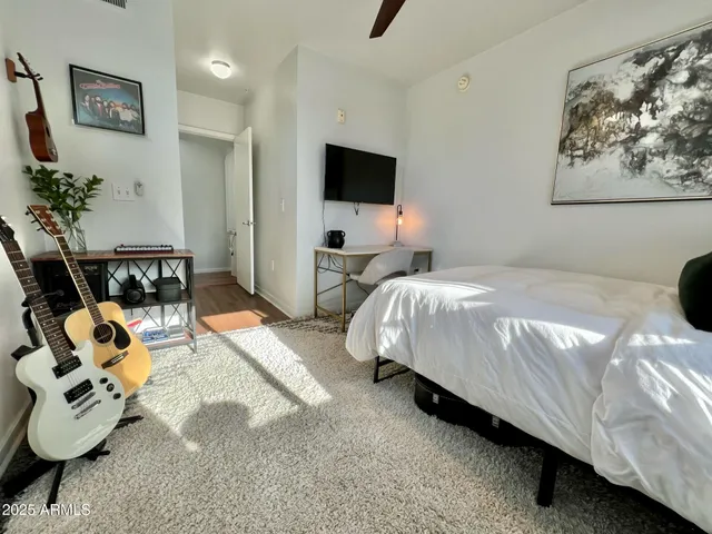 a view of staircase with railing and a rug