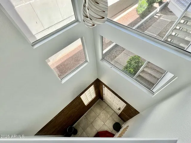 a view of a building with potted plants and large trees