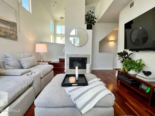 a living room with furniture a mirror and a fireplace