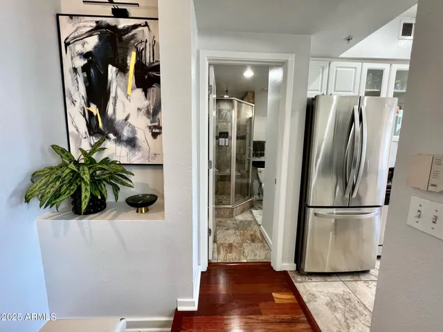 a view of a room with wooden floor and a potted plant