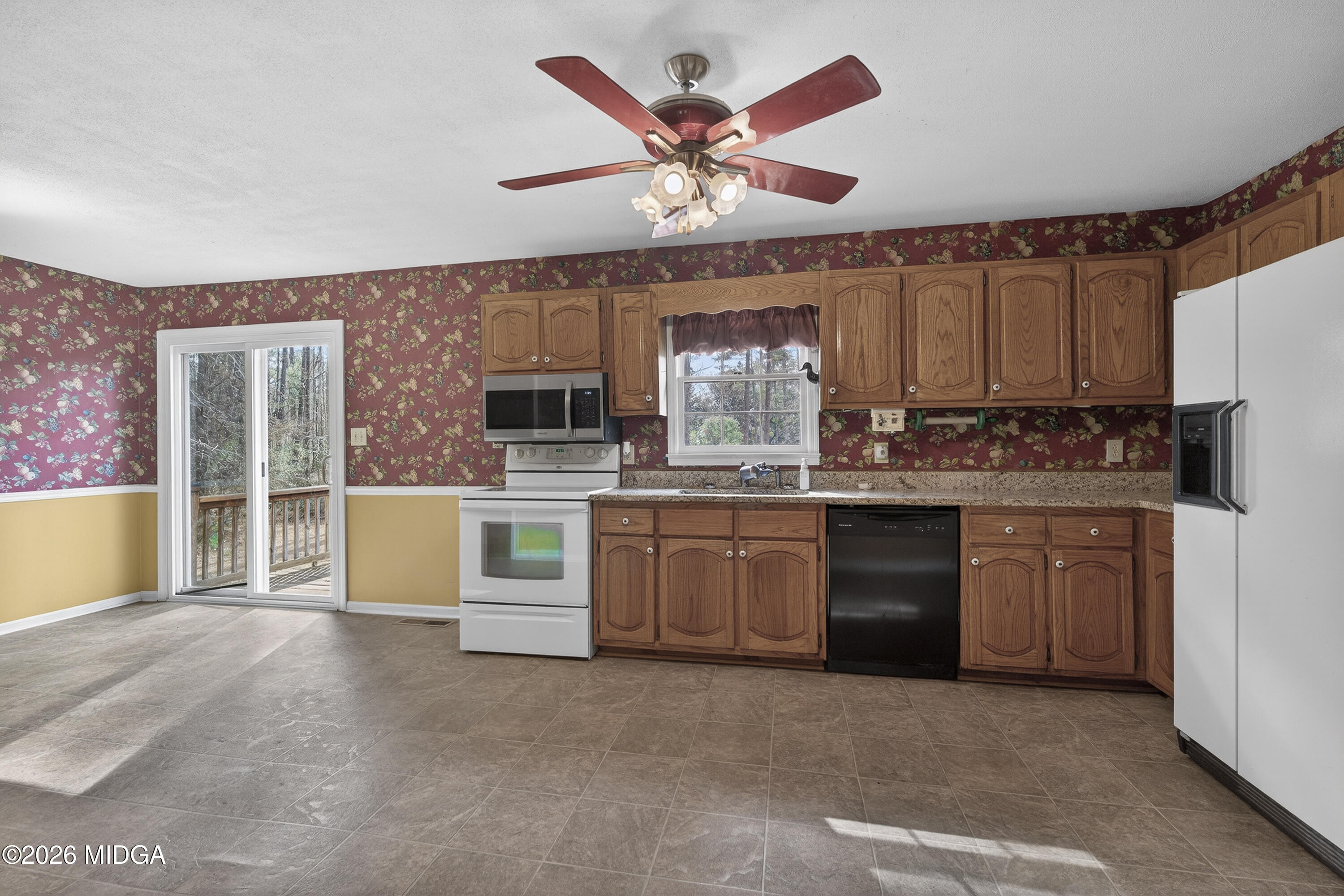 337 Highway 18 Gray, GA 31032 - Photo 16 of 50 a kitchen with a stove a sink and a refrigerator