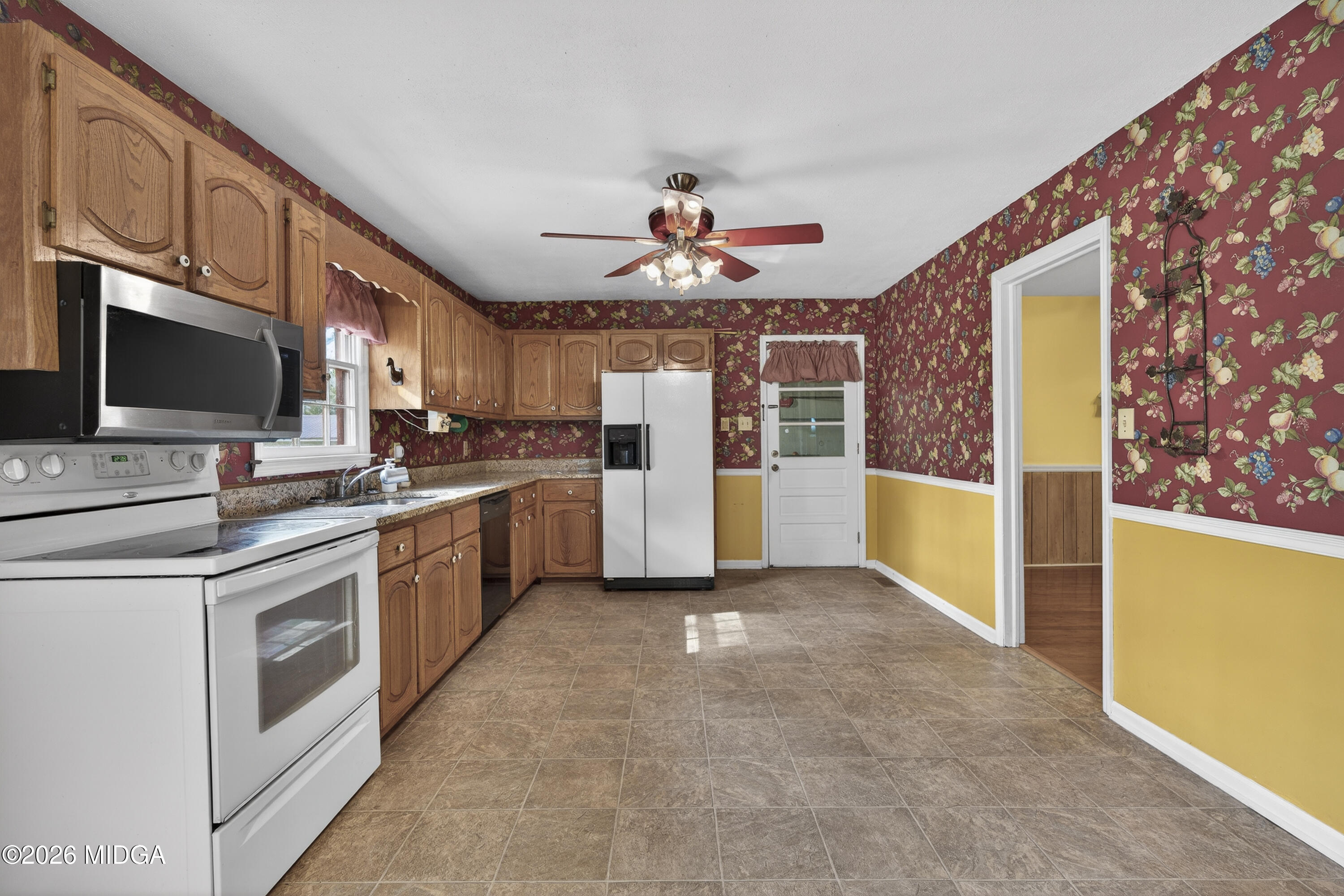 337 Highway 18 Gray, GA 31032 - Photo 20 of 50 a kitchen with stainless steel appliances kitchen island granite countertop a refrigerator a stove top oven a chimney cabinets and a dining table