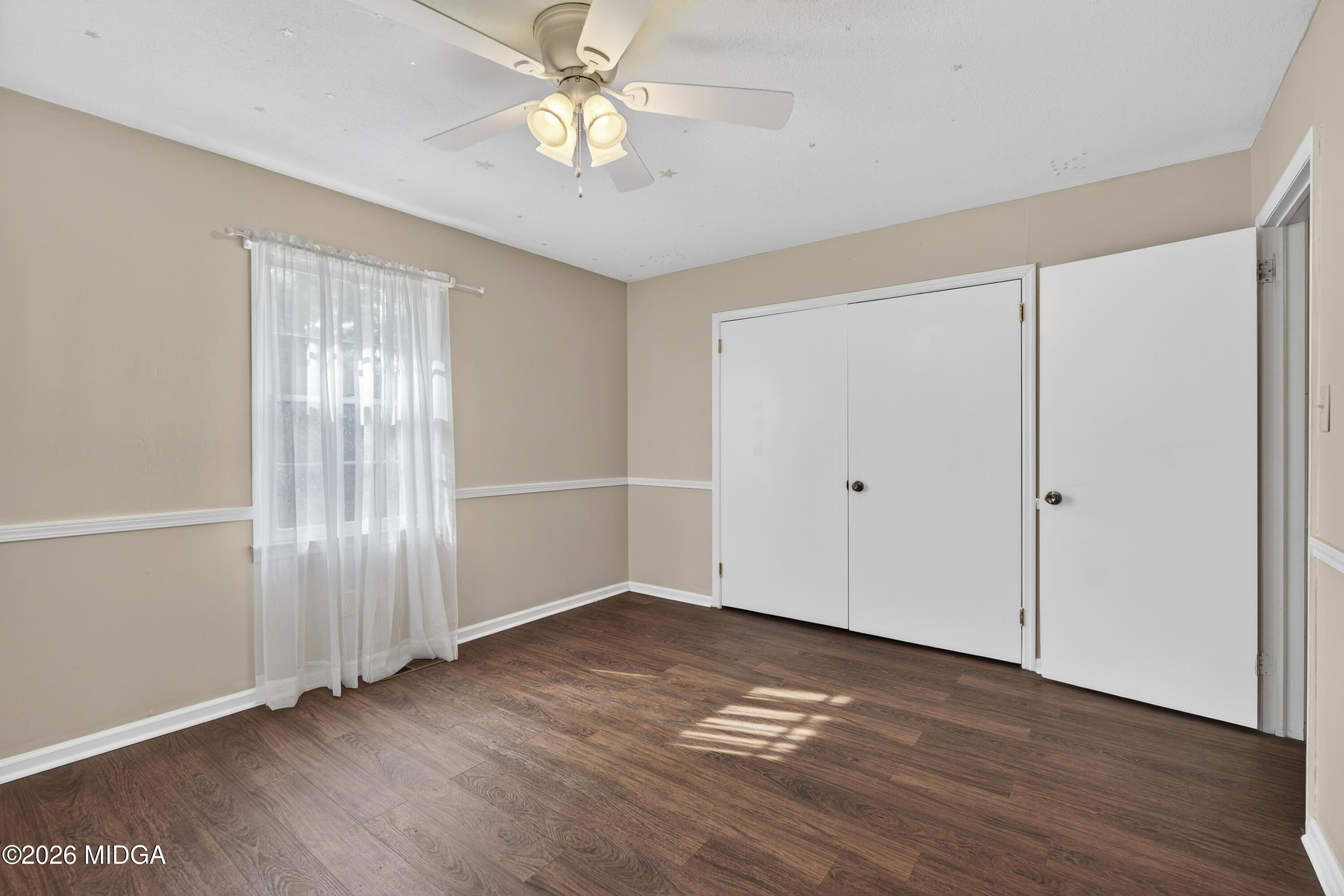 337 Highway 18 Gray, GA 31032 - Photo 25 of 50 an empty room with wooden floor and windows