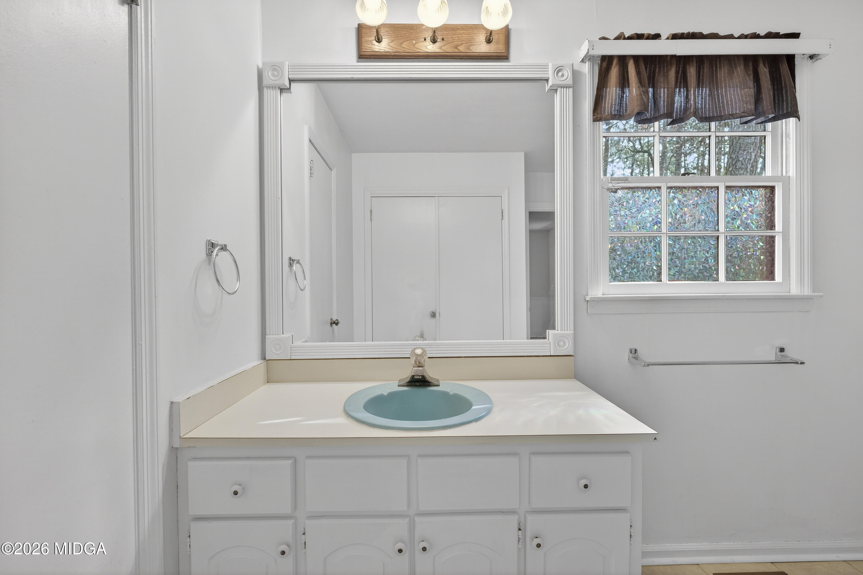 337 Highway 18 Gray, GA 31032 - Photo 29 of 50 a bathroom with a sink a vanity and a window